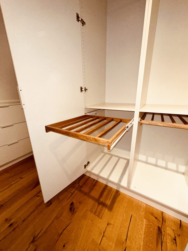 Offener Schrank mit Hosenauszügen